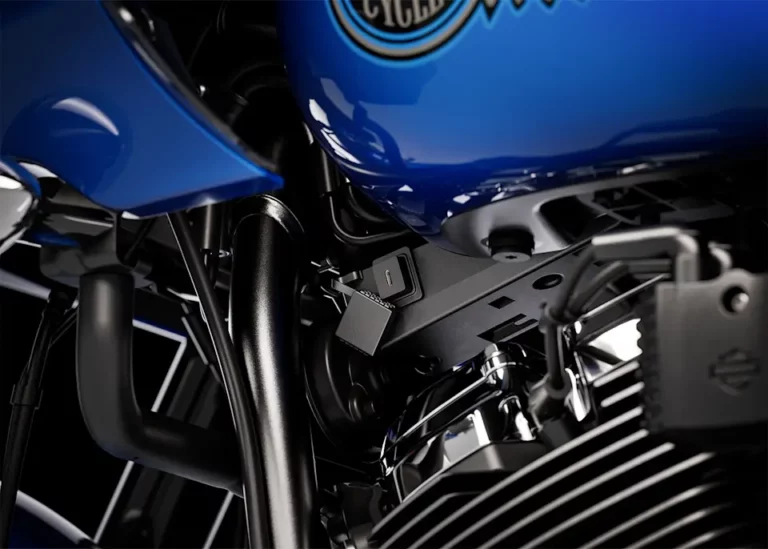 Detailaufnahme des Motors einer Harley-Davidson mit blauer Lackierung und sichtbaren Komponenten für Zubehör und Wartung.