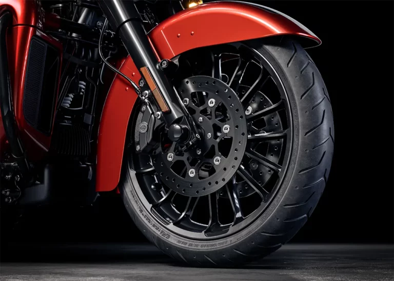 Nahaufnahme des Vorderrads einer Harley-Davidson mit markantem Design und leistungsstarker Bremse.