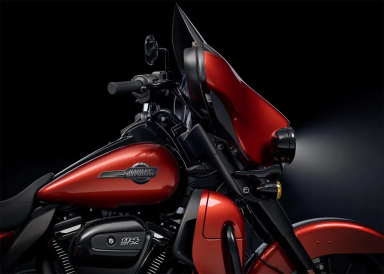 Detailansicht eines modernen Harley-Davidson Motorrads in leuchtendem Rot mit schwarzem Rahmen und Zubehör.